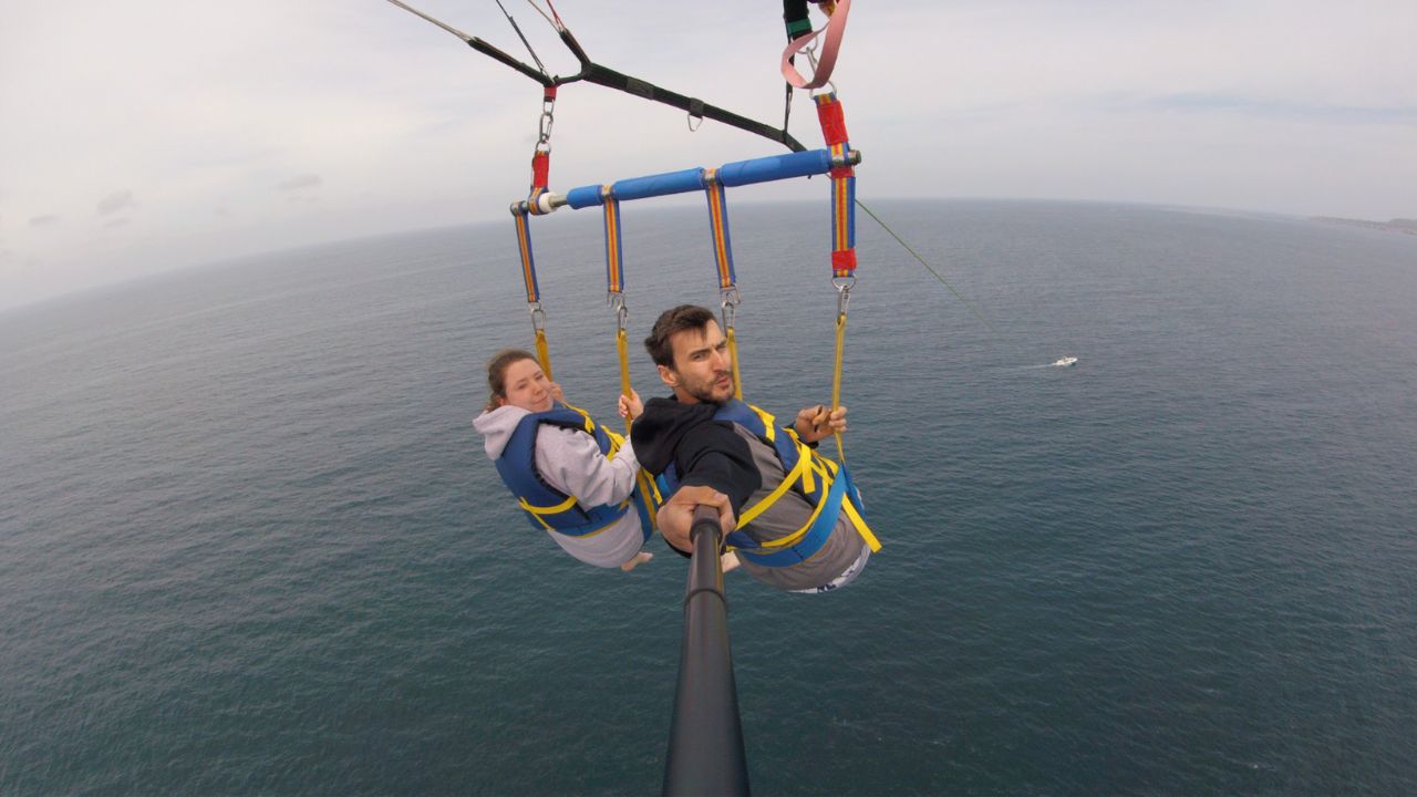 Couple enjoying a scenic tandem parasailing experience