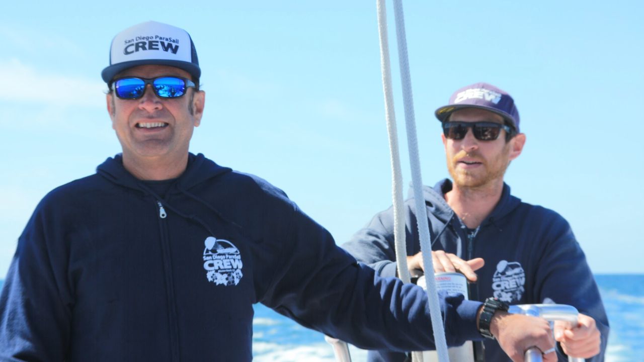 Experienced San Diego Parasail crew preparing guests for a safe parasailing adventure.