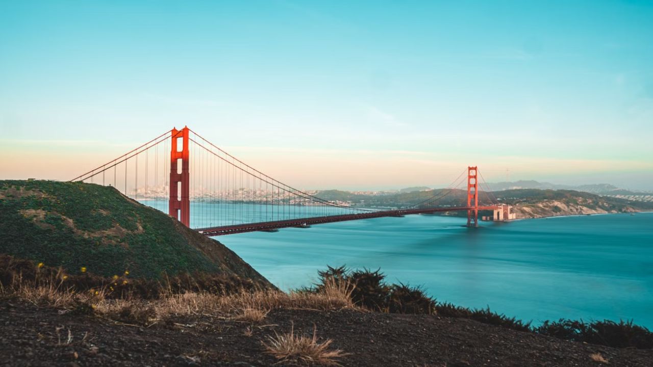 Panoramic view of the Golden Gate Bridge spanning San Francisco Bay on a clear California day.