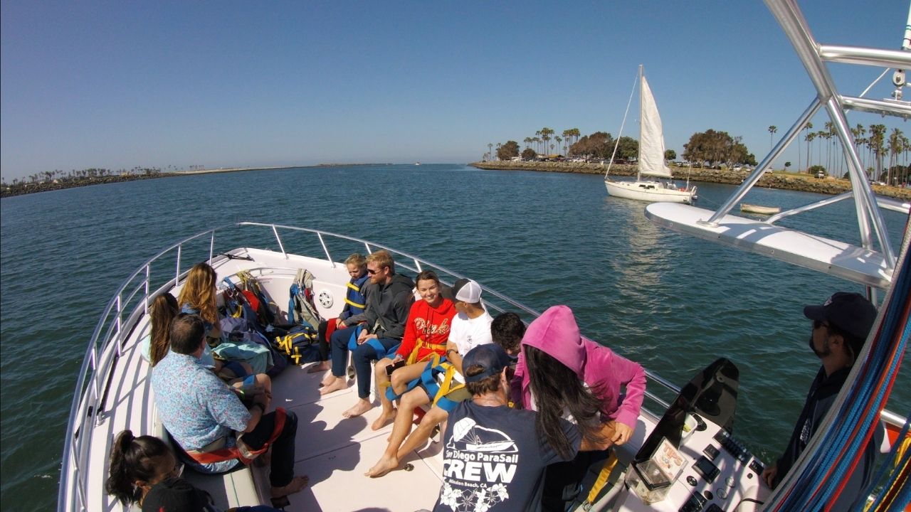 Guests relaxing aboard a San Diego parasailing boat on a sunny day.
