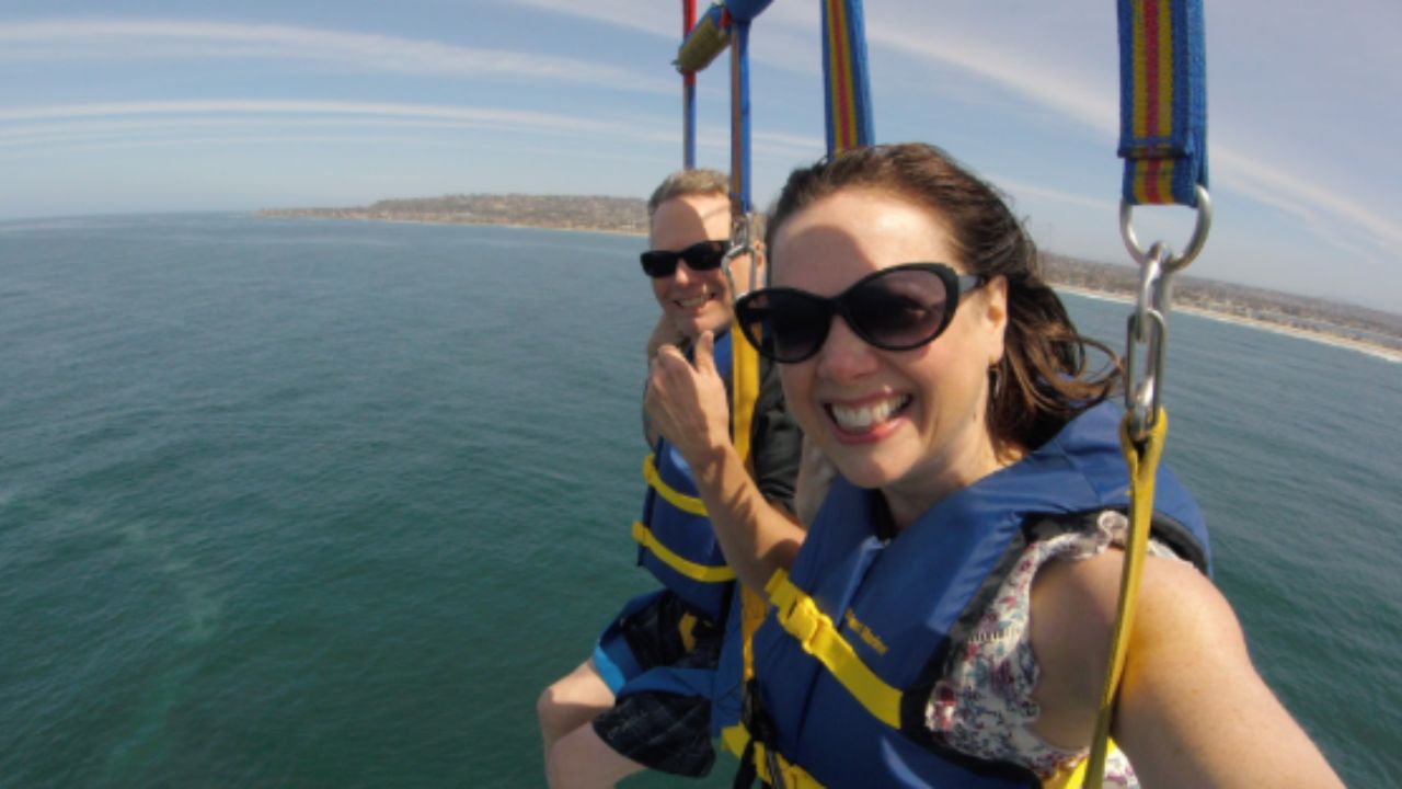Couple enjoying parasailing ride.